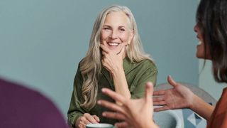 two women smiling having a conversation