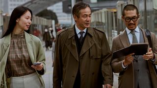 Whitepaper cover with image of three business colleagues walking outside in coats with one using a laptop