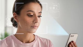 Girl looking at a smartphone with digital scanning icons surrounding her face