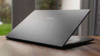 A photograph of the MSI Prestige 14 Evo on a table from behind