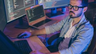 An AWS eBook on the three keys to successful generative AI implementations , with image of man at workstation with multi screens