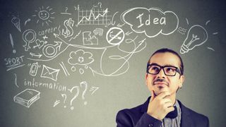Image of a man thinking in front of a board filled with abstract ideas