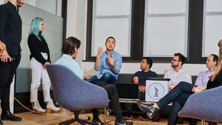 Whitepaper from IBM on how to create the ideal customer experience, with image of colleagues in a meeting