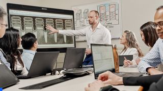 Whitepaper on Generative AI and ML for the enterprise, with image of colleagues in a conference room with latops and presentation screen