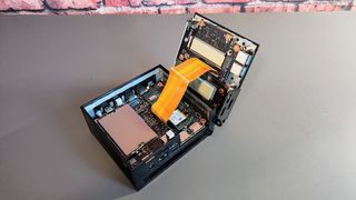 The Asus PN53 Mini PC open and on a desk