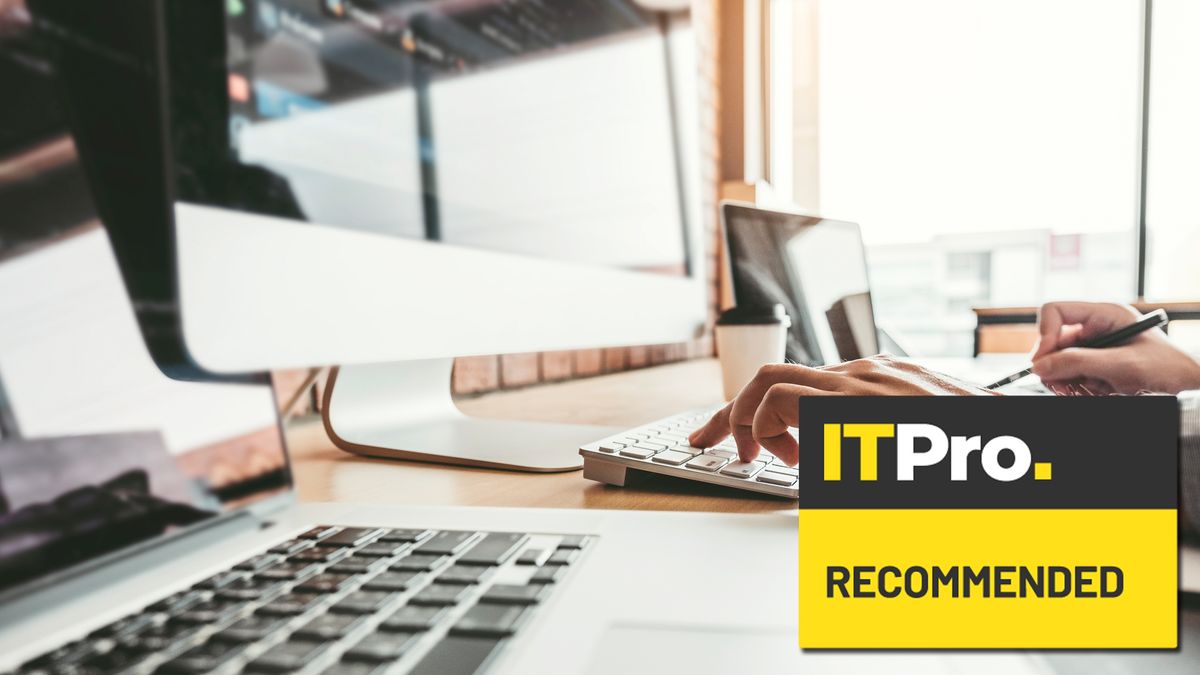 man typing on desktop in office