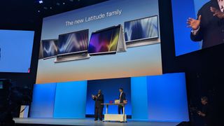 Chuck Whitten and Ed Ward on stage showing off the new Dell Latitude laptops, with a large screen behind them showing off the devices.