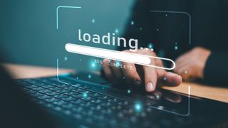 A hand on a keyboard with a loading graphic