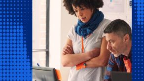Image of female and male colleagues looking at a computer