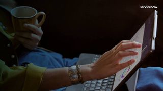 Woman's hand touch a laptop screen