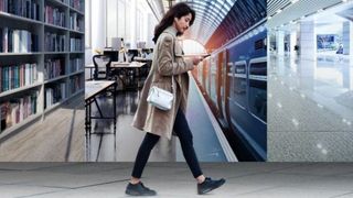 Image of girl walking looking down into a mobile device, with changing backgrounds behind her as she walks
