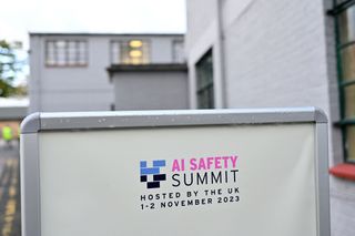 AI Safety Summit advertisement pictured on a board at Bletchley Park, UK.