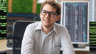 Man with glasses smiling looking forward