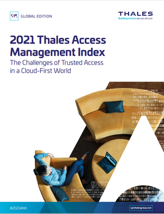 Bird's eye view of a woman sitting on a circular couch looking at a laptop 