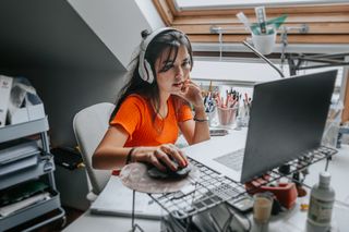 A young female student working on a desktop computer