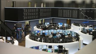 Whitepaper cover with image of the stock exchange with vast banks of computers and dual screens