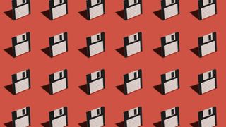 Floppy disks pictured lined up against a red colored backdrop.