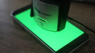 An iPhone 14 with a calibrator