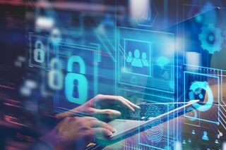 A man typing on a keyboard with cloud computing symbols around him